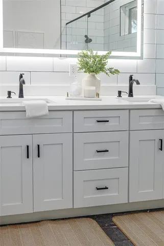 a kitchen with white cabinets and a sink
