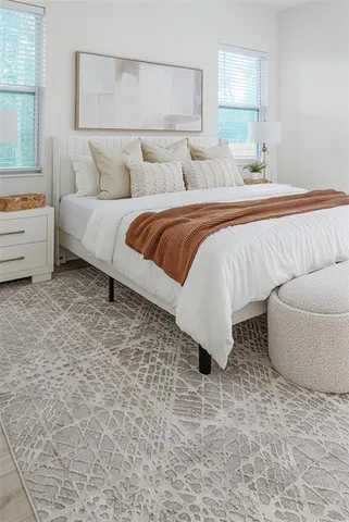 a bedroom with a bed and a window