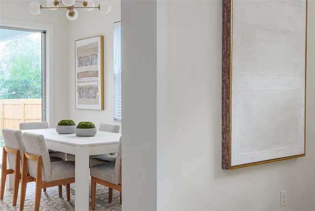 a view of a dining room with furniture and window