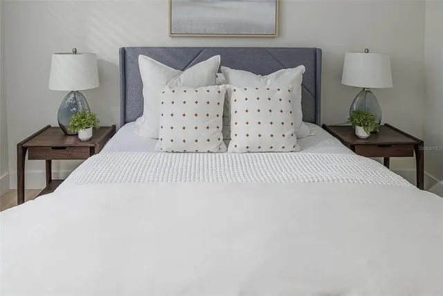 a large white bed in a white room