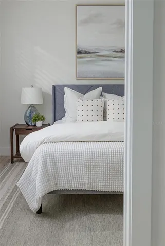 a bedroom with a bed and lamp