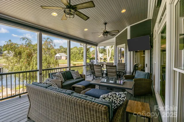 a living room with furniture and a floor to ceiling window