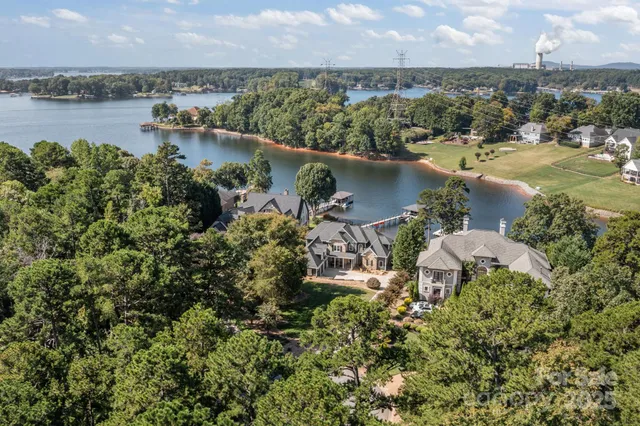 an aerial view of a houses with ocean view