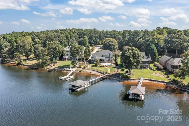 a view of a lake with lawn chairs