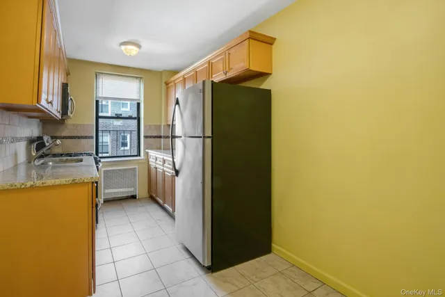 a kitchen with a refrigerator and a sink
