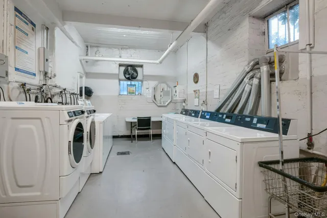 a utility room with multiple dryer and washer