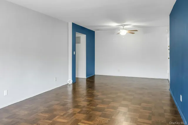 a view of an empty room with a fan