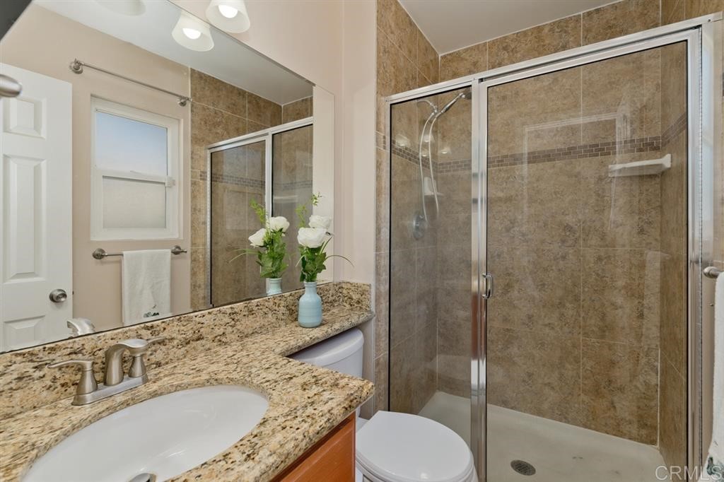 9456 Cathywood Drive Santee, CA 92071 - Photo 12 of 25 a bathroom with a granite countertop sink toilet and shower