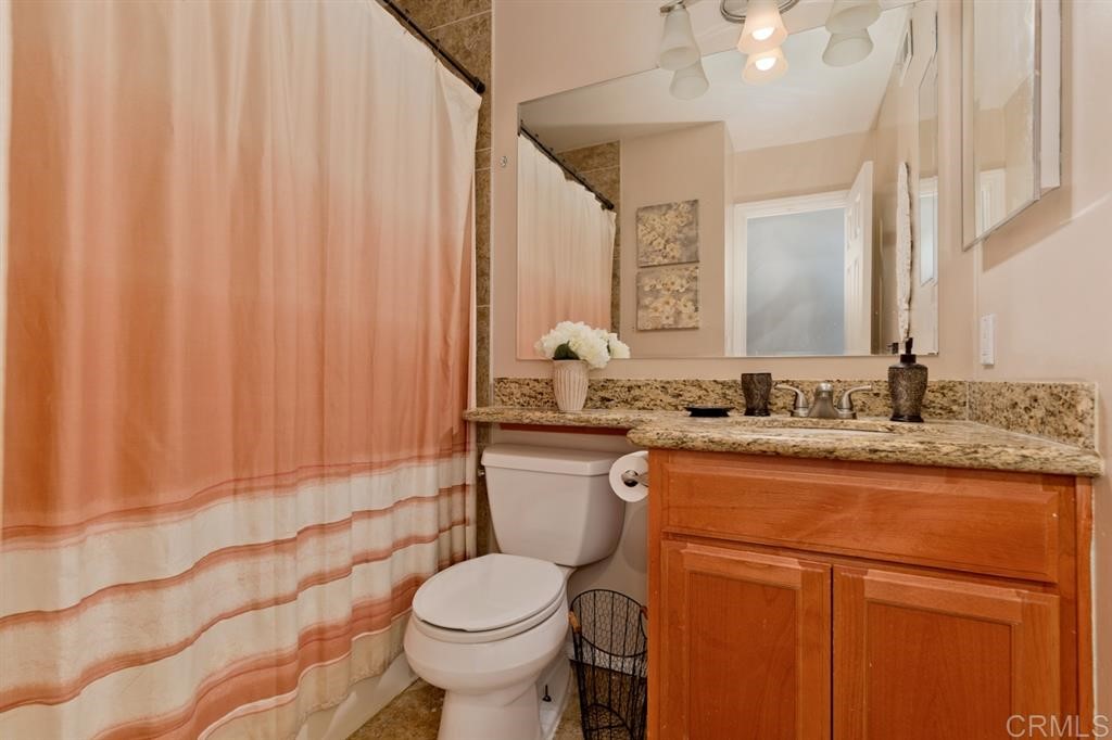 9456 Cathywood Drive Santee, CA 92071 - Photo 17 of 25 a bathroom with a granite countertop sink and a toilet