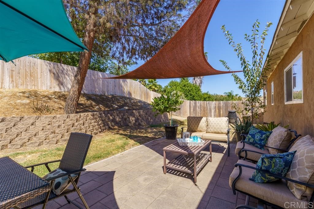 9456 Cathywood Drive Santee, CA 92071 - Photo 19 of 25 an outdoor sitting area with furniture and umbrella