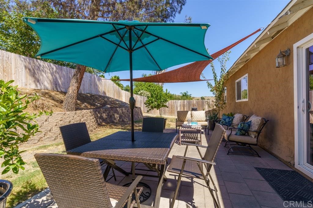 9456 Cathywood Drive Santee, CA 92071 - Photo 23 of 25 a patio with a patio table and chairs