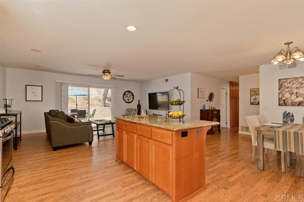 9456 Cathywood Drive Santee, CA 92071 - Photo 10 of 25 a living room with furniture a dining table and wooden floor