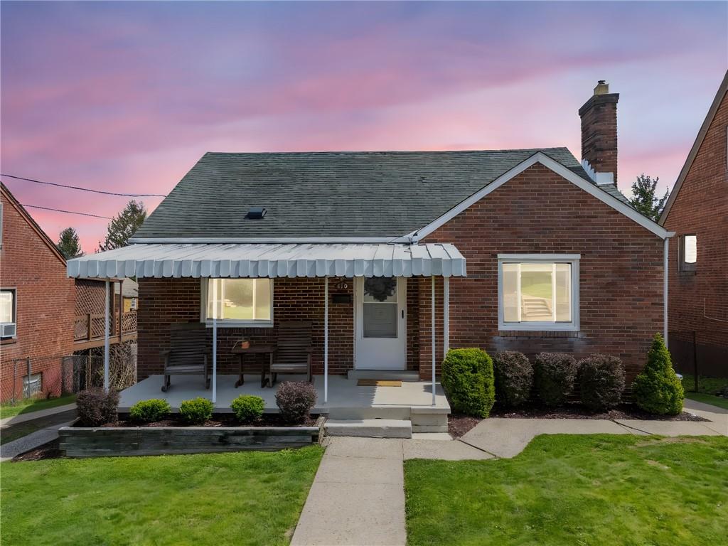 416 Phillips Avenue McKees Rocks, PA 15136 - Photo 1 of 46 a front view of a house with a yard and potted plants