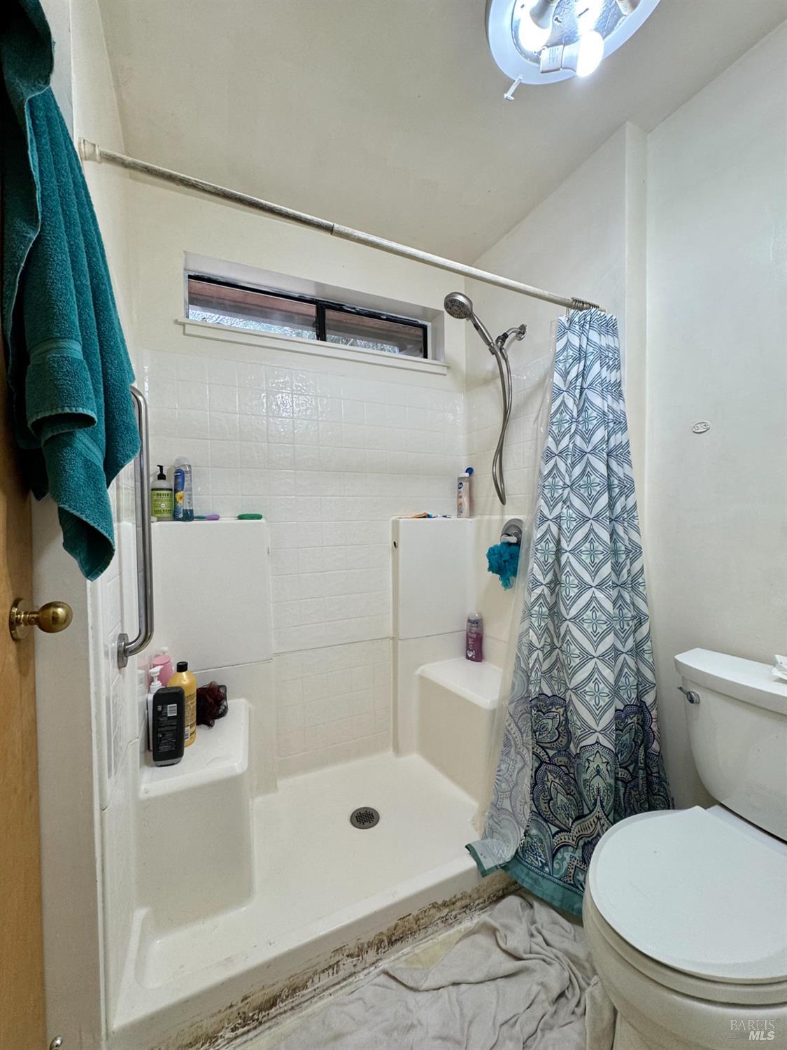 5083 Dry Creek Road Napa, CA 94558 - Photo 15 of 90 a bathroom with a shower and a toilet
