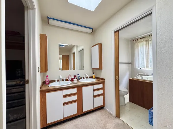 a kitchen with granite countertop a sink a counter space and cabinets