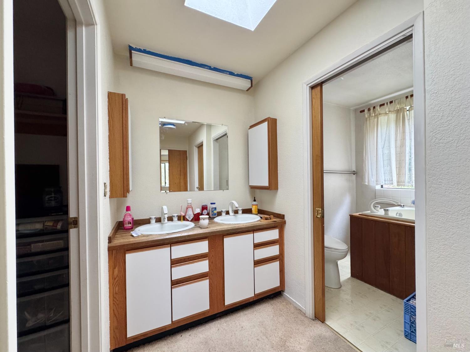 5083 Dry Creek Road Napa, CA 94558 - Photo 23 of 90 a bathroom with a double vanity sink and mirror