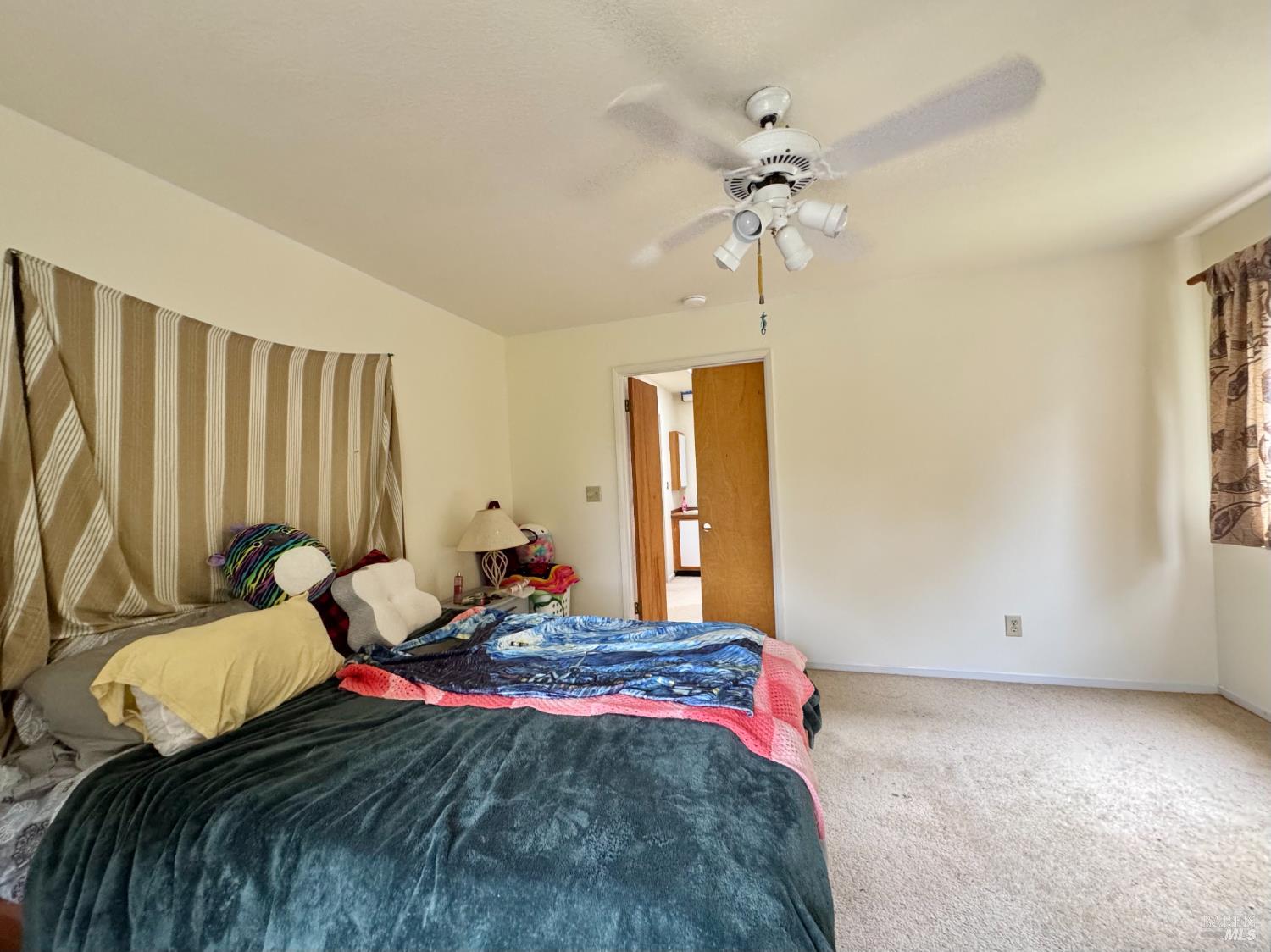 5083 Dry Creek Road Napa, CA 94558 - Photo 25 of 90 a bedroom with a bed and a chandelier