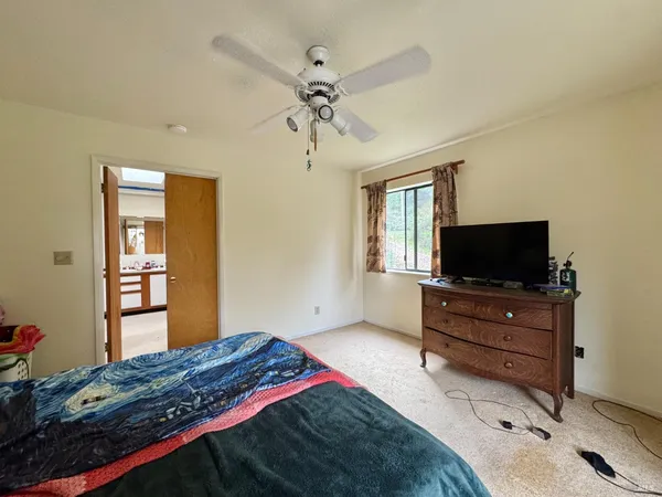 an empty room with windows and cabinet