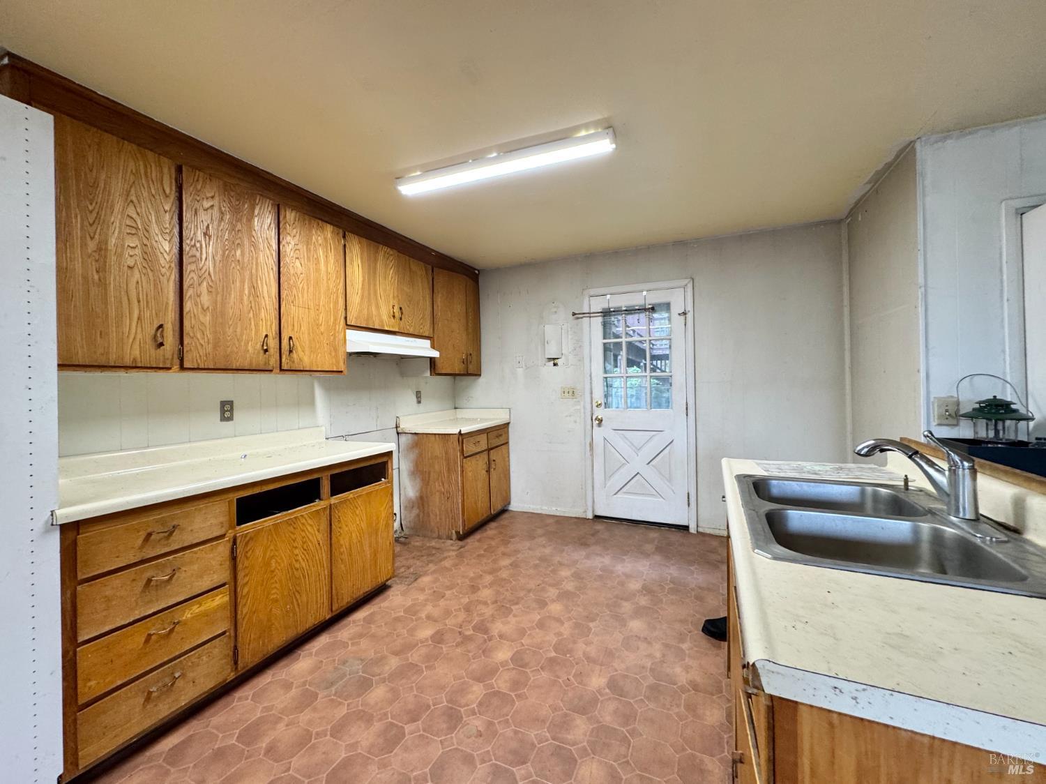 5083 Dry Creek Road Napa, CA 94558 - Photo 39 of 90 a kitchen with granite countertop a sink a counter space and cabinets