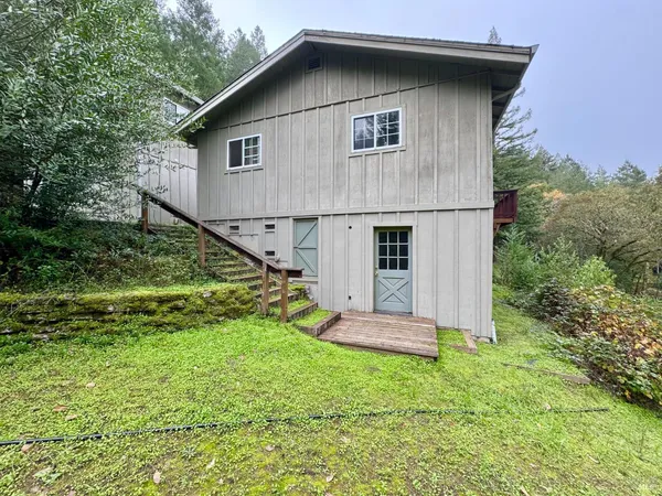 an aerial view of a house with a yard and sitting area