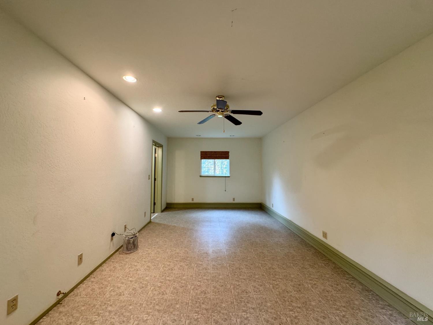 5083 Dry Creek Road Napa, CA 94558 - Photo 57 of 90 an empty room with a ceiling fan and windows
