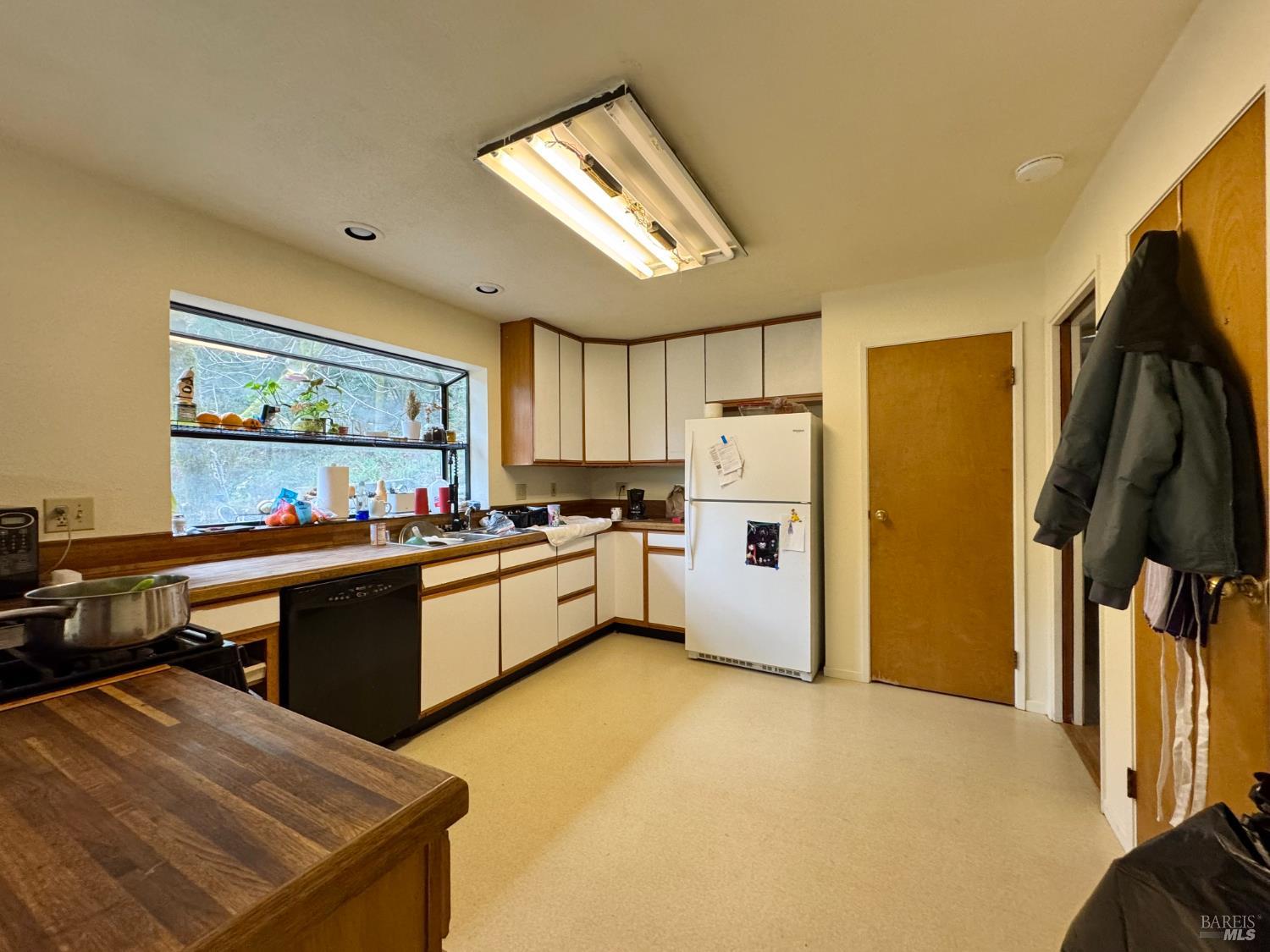 5083 Dry Creek Road Napa, CA 94558 - Photo 10 of 90 a kitchen with stainless steel appliances kitchen island granite countertop a refrigerator and a stove top oven
