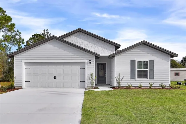 a view of kitchen with granite countertop refrigerator oven and white cabinets