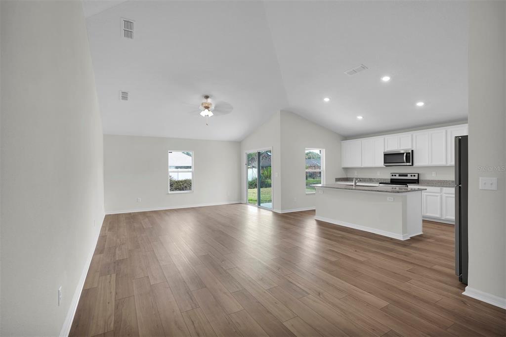 2 Prince Eric Lane Palm Coast, FL 32164 - Photo 2 of 20 a view of kitchen with granite countertop refrigerator oven and white cabinets