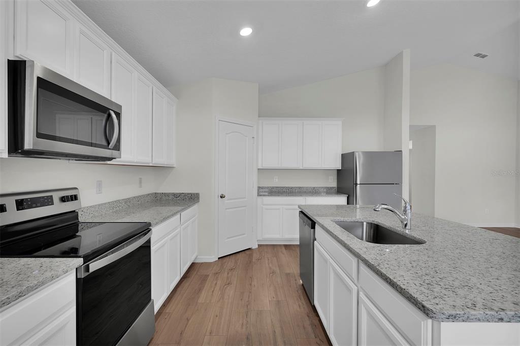 2 Prince Eric Lane Palm Coast, FL 32164 - Photo 5 of 20 a kitchen with stainless steel appliances granite countertop a sink stove and oven