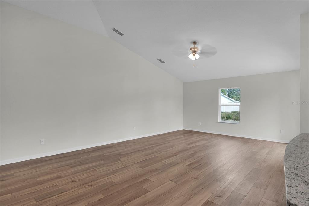 2 Prince Eric Lane Palm Coast, FL 32164 - Photo 7 of 20 an empty room with wooden floor and windows