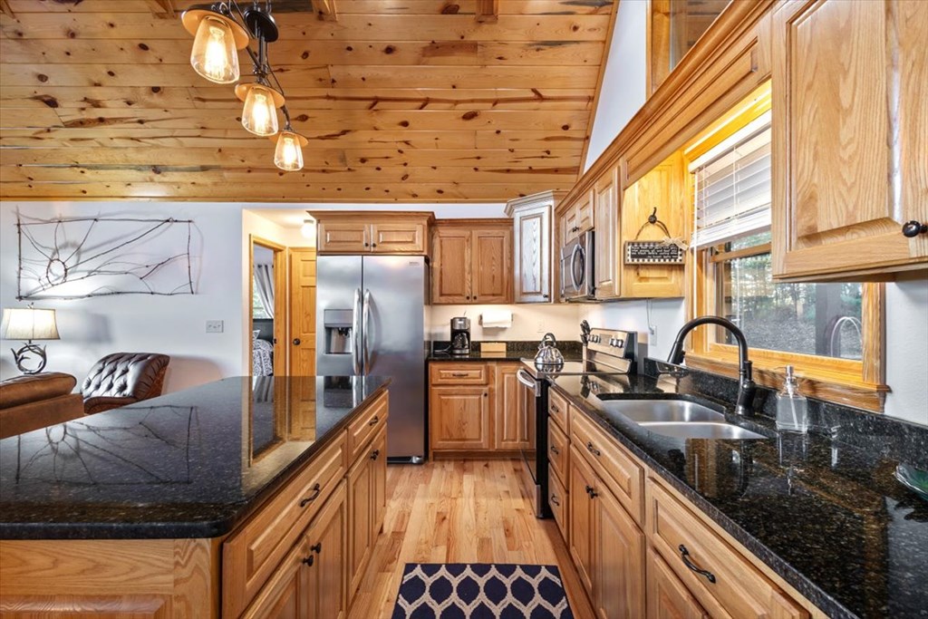 190 Regency Drive Murphy, NC 28906 - Photo 20 of 42 a kitchen with stainless steel appliances granite countertop a sink stove and refrigerator