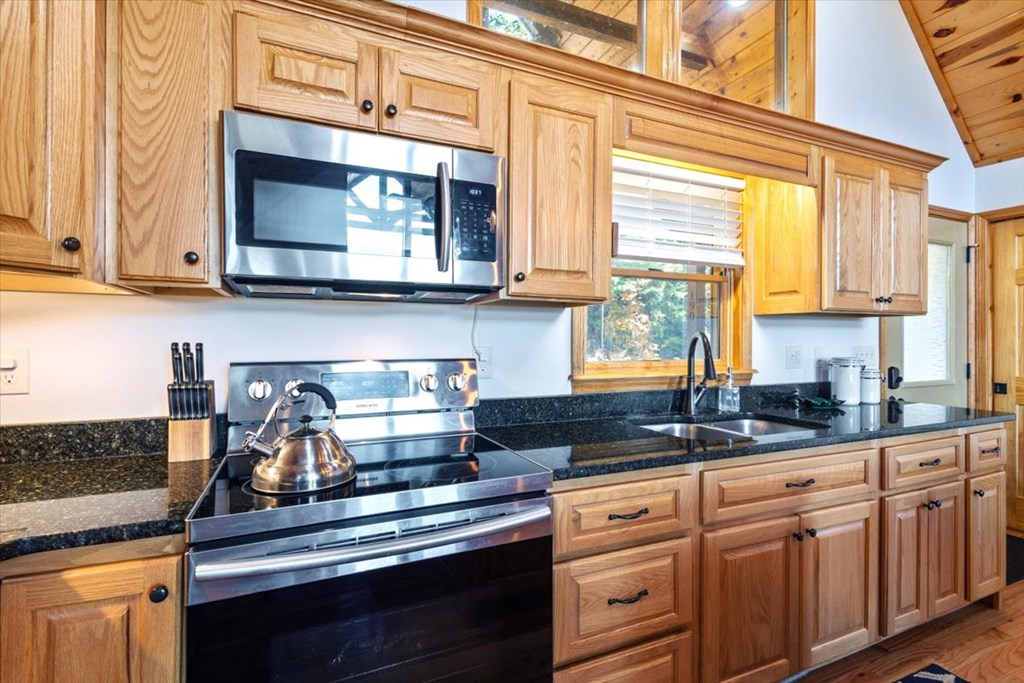190 Regency Drive Murphy, NC 28906 - Photo 23 of 42 a kitchen with granite countertop white cabinets and appliances