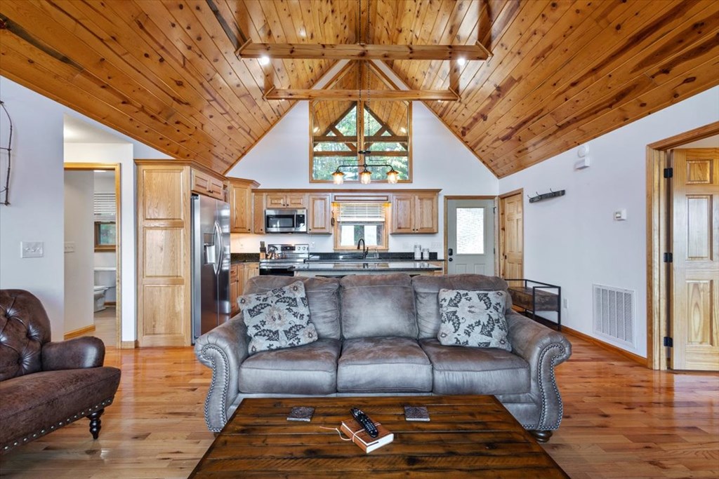 190 Regency Drive Murphy, NC 28906 - Photo 25 of 42 a living room with a couch and a chandelier