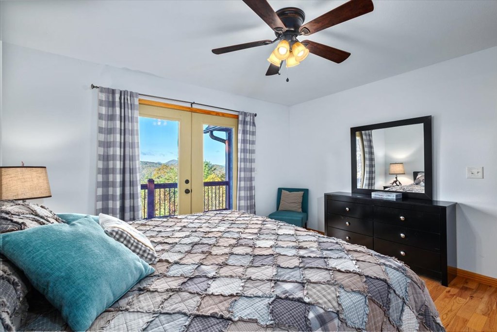 190 Regency Drive Murphy, NC 28906 - Photo 29 of 42 a bedroom with a bed and a chandelier fan