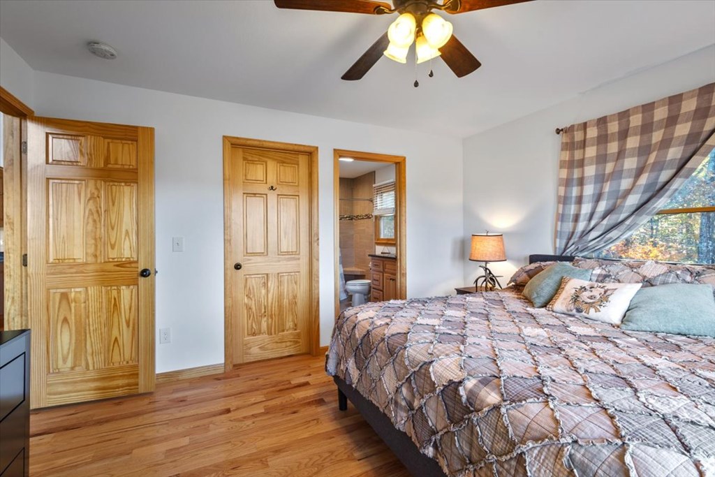 190 Regency Drive Murphy, NC 28906 - Photo 30 of 42 a bedroom with a bed and wooden floor