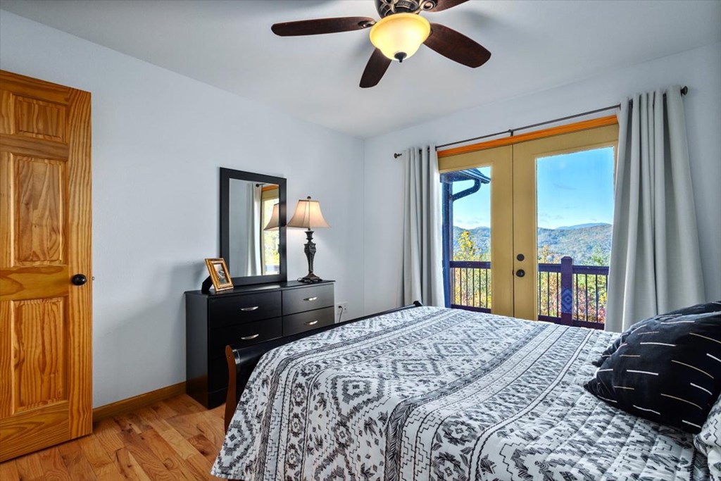 190 Regency Drive Murphy, NC 28906 - Photo 36 of 42 a bedroom with a bed and wooden floor