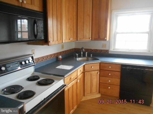 1801 Edgewood Road Baltimore, MD 21286 - Photo 3 of 6 a kitchen with a sink a stove and cabinets