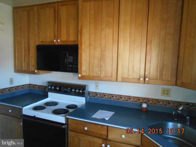 1801 Edgewood Road Baltimore, MD 21286 - Photo 4 of 6 a kitchen with a stove and a cabinet