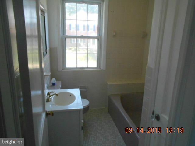 1801 Edgewood Road Baltimore, MD 21286 - Photo 5 of 6 a bathroom with a sink and mirror