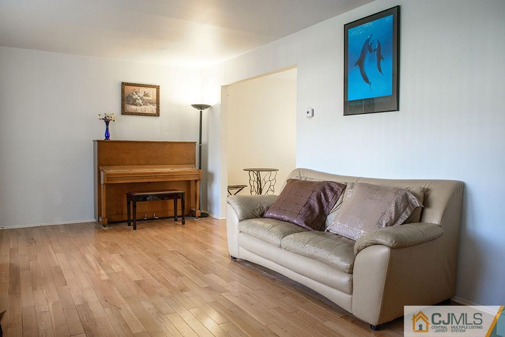 56 Brookside Road Edison, NJ 08817 - Photo 11 of 24 a living room with furniture and a piano