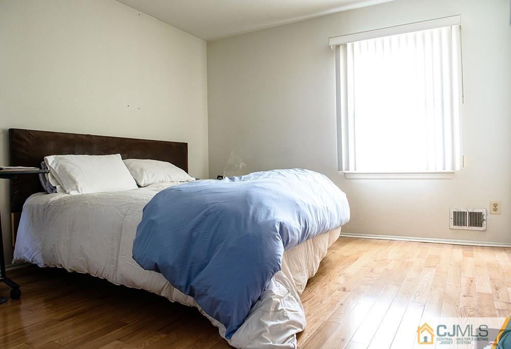56 Brookside Road Edison, NJ 08817 - Photo 16 of 24 a bedroom with a bed and a window