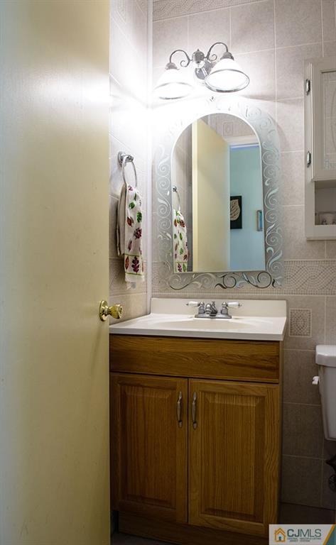 56 Brookside Road Edison, NJ 08817 - Photo 9 of 24 a bathroom with a sink and a mirror