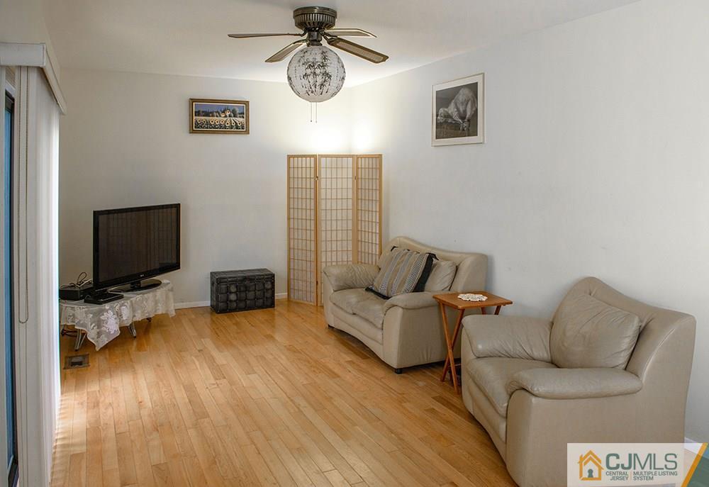 56 Brookside Road Edison, NJ 08817 - Photo 10 of 24 a living room with furniture and a flat screen tv
