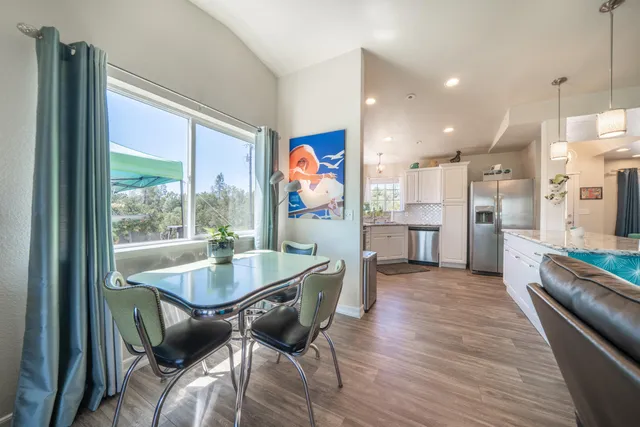 a bathroom with a granite countertop sink a toilet a mirror and shower