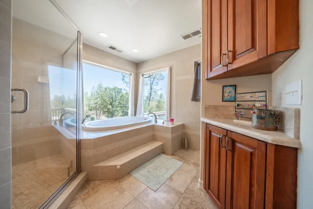 a view of a balcony with wooden floor and outdoor seating