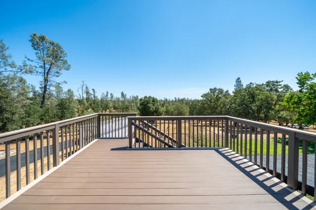 a view of a house with backyard porch and sitting area