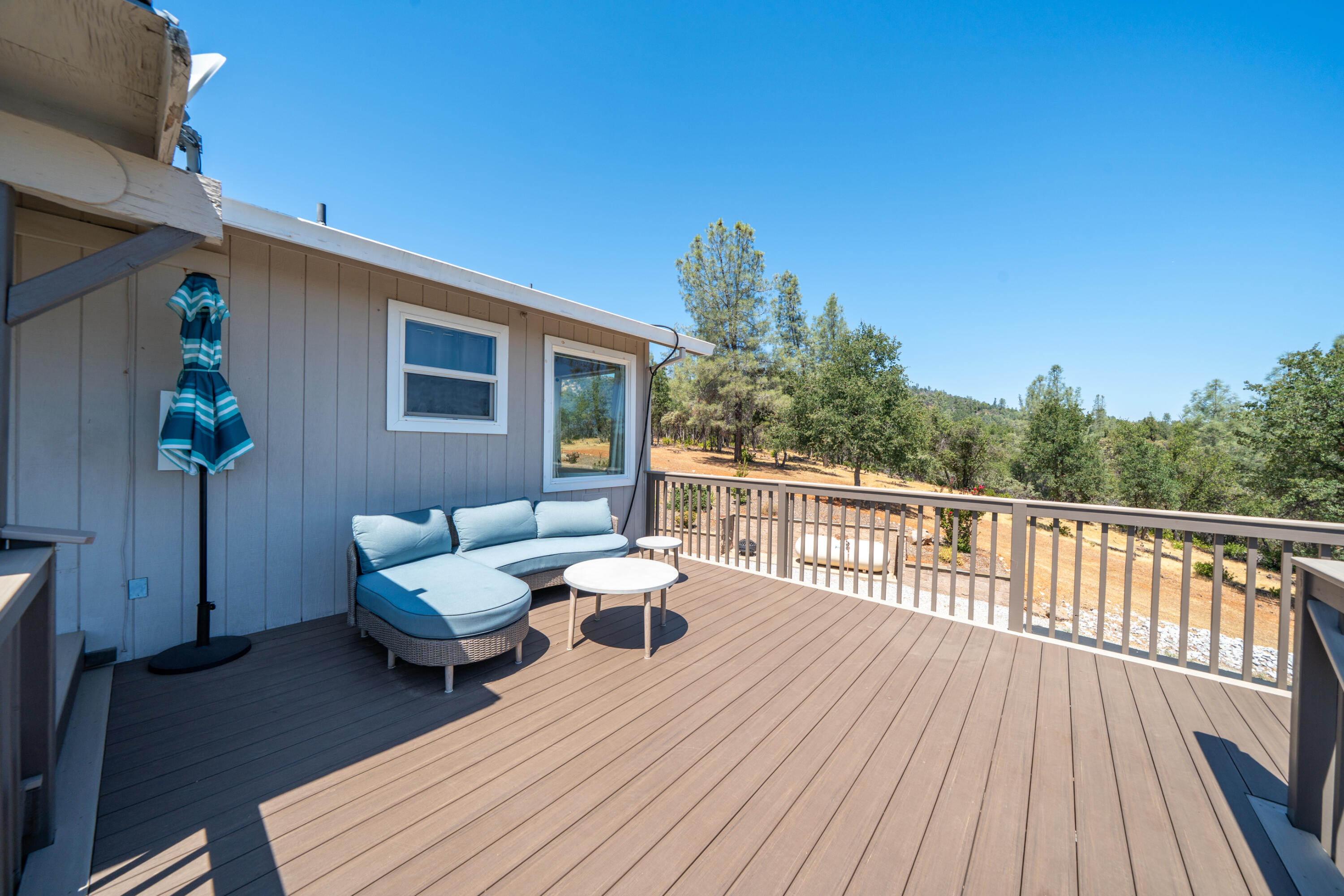 7954 Placer Road Redding, CA 96001 - Photo 30 of 97 a balcony with wooden floor and outdoor seating