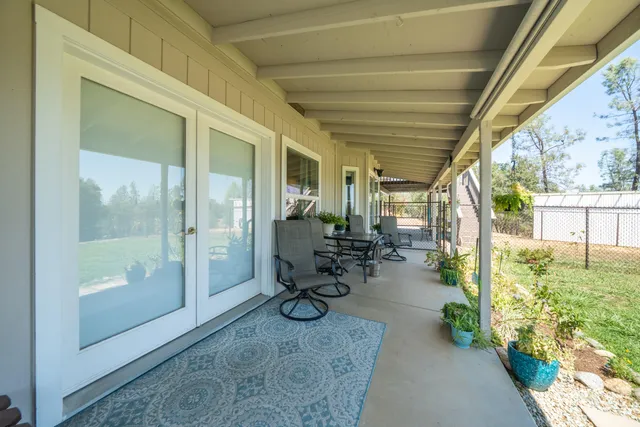 a view of a house with backyard porch and sitting area