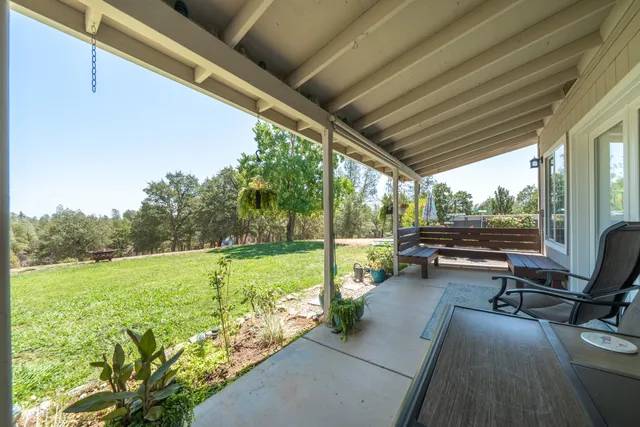 a terrace of a house with outdoor seating