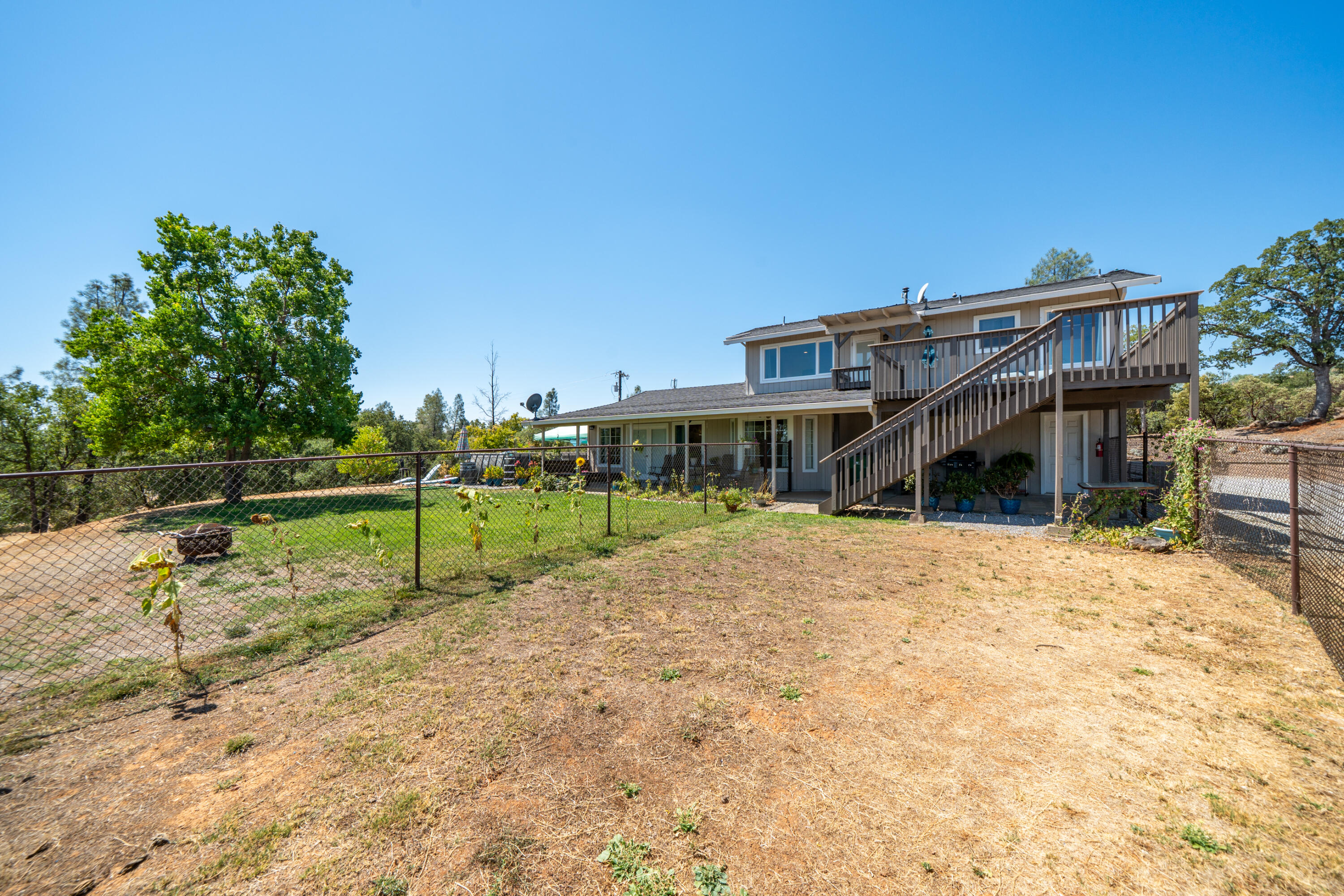 7954 Placer Road Redding, CA 96001 - Photo 40 of 97 a view of a house with backyard and sitting area